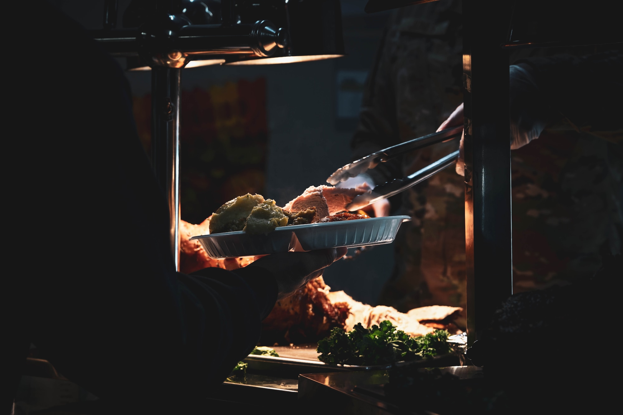 A plate of food is served during a Thanksgiving meal at the dining facility.