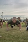 U.S. Marine Corps Recruit Baily Cureton, with Bravo Company, 1st Recruit Training Battalion, executes dynamic warm-ups prior to a physical training event at Marine Corps Recruit Depot San Diego, California, Nov. 27, 2024. The recruits conducted a series of stations such as side shuffles, ammunition can lifts, planks, single-leg Romanian deadlifts, bicycle crunches, and 440-yard sprints during their physical training event, strengthening themselves physically and mentally.  (U.S. Marine Corps photo by Cpl. Alexandra M. Earl)