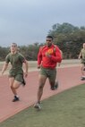 U.S. Marine Corps Drill Instructor Sgt. Manuel Delarosa, right, with Bravo Company, 1st Recruit Training Battalion, guides recruits through a 440-yard sprint during a physical training event at Marine Corps Recruit Depot San Diego, California, Nov. 27, 2024. The recruits conducted a series of stations such as side shuffles, ammunition can lifts, planks, single-leg Romanian deadlifts, bicycle crunches, and 440-yard sprints during their physical training event, strengthening themselves physically and mentally.  (U.S. Marine Corps photo by Cpl. Alexandra M. Earl)