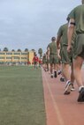 U.S. Marine Corps recruits with Bravo Company, 1st Recruit Training Battalion, perform active cool downs during a physical training event at Marine Corps Recruit Depot San Diego, California, Nov. 27, 2024. The recruits conducted a series of stations such as side shuffles, ammunition can lifts, planks, single-leg Romanian deadlifts, bicycle crunches, and 440-yard sprints during their physical training event, strengthening themselves physically and mentally. (U.S. Marine Corps photo by Cpl. Alexandra M. Earl)
