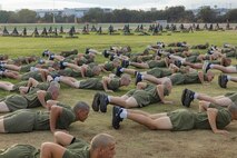 U.S. Marine Corps recruits with Bravo Company, 1st Recruit Training Battalion, execute dynamic warm-ups prior to a physical training event at Marine Corps Recruit Depot San Diego, California, Nov. 27, 2024. The recruits conducted a series of stations such as side shuffles, ammunition can lifts, planks, single-leg Romanian deadlifts, bicycle crunches, and 440-yard sprints during their physical training event, strengthening themselves physically and mentally.  (U.S. Marine Corps photo by Cpl. Alexandra M. Earl)