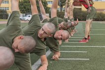 U.S. Marine Corps recruits with Bravo Company, 1st Recruit Training Battalion, execute a side plank during a physical training event at Marine Corps Recruit Depot San Diego, California, Nov. 27, 2024. The recruits conducted a series of stations such as side shuffles, ammunition can lifts, planks, single-leg Romanian deadlifts, bicycle crunches, and 440-yard sprints during their physical training event, strengthening themselves physically and mentally. (U.S. Marine Corps photo by Cpl. Alexandra M. Earl)