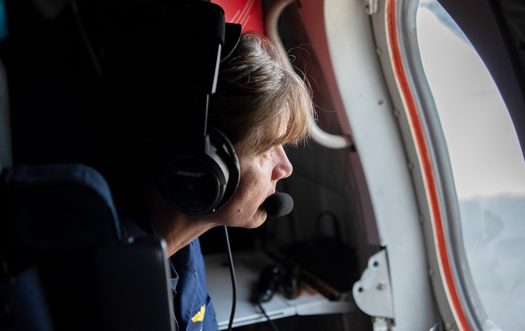 U.S. Coast Guard Capt. Tina Pena, chief of staff of the Seventh District, assesses the damage in western Florida caused by Hurricane Ian from an HC-144 airplane, Oct. 1, 2022. Crews in the air and on the ground continue to conduct search and rescue, damage assessment, and pollution assessment.
(U.S. Coast Guard photo by Petty Officer 2nd Class Ronald Hodges)