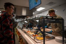 U.S. Air Force Senior Master Sgt. Dennis Kolesnik, right, the Nevada Test and Training Range senior enlisted leader, serves Thanksgiving meals at the Crosswinds Dining Facility, Nellis Air Force Base, Nevada, Nov. 28, 2024.