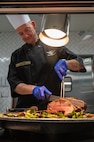 U.S. Air Force Warfare Center Commander Maj. Gen. Christopher Niemi, carves roast beef during Thanksgiving at the Crosswinds Dining Facility, Nellis Air Force Base, Nevada, Nov. 28, 2024.
