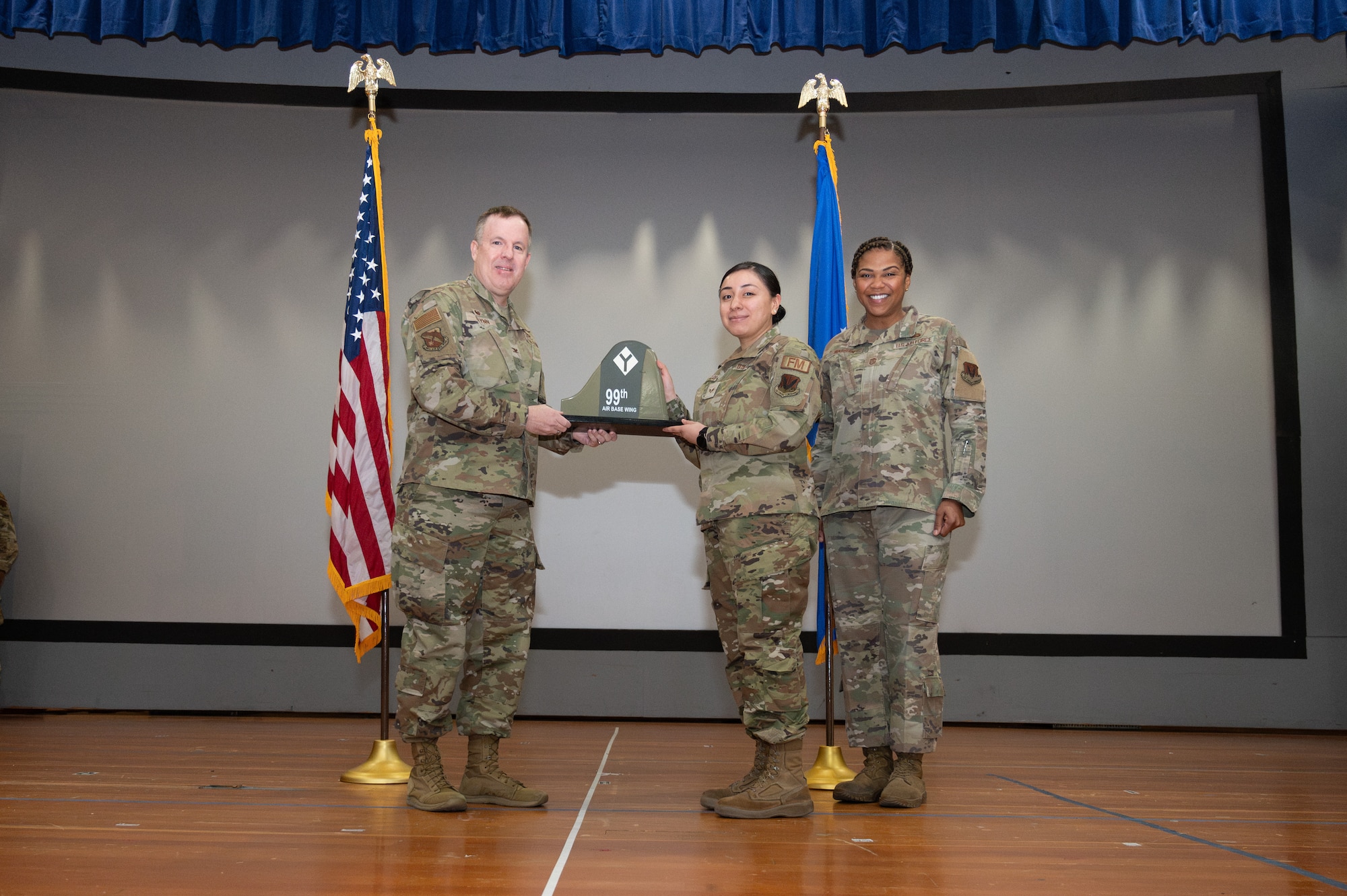 An Airman receives an award from U.S. Air Force Col. Jason Glynn.