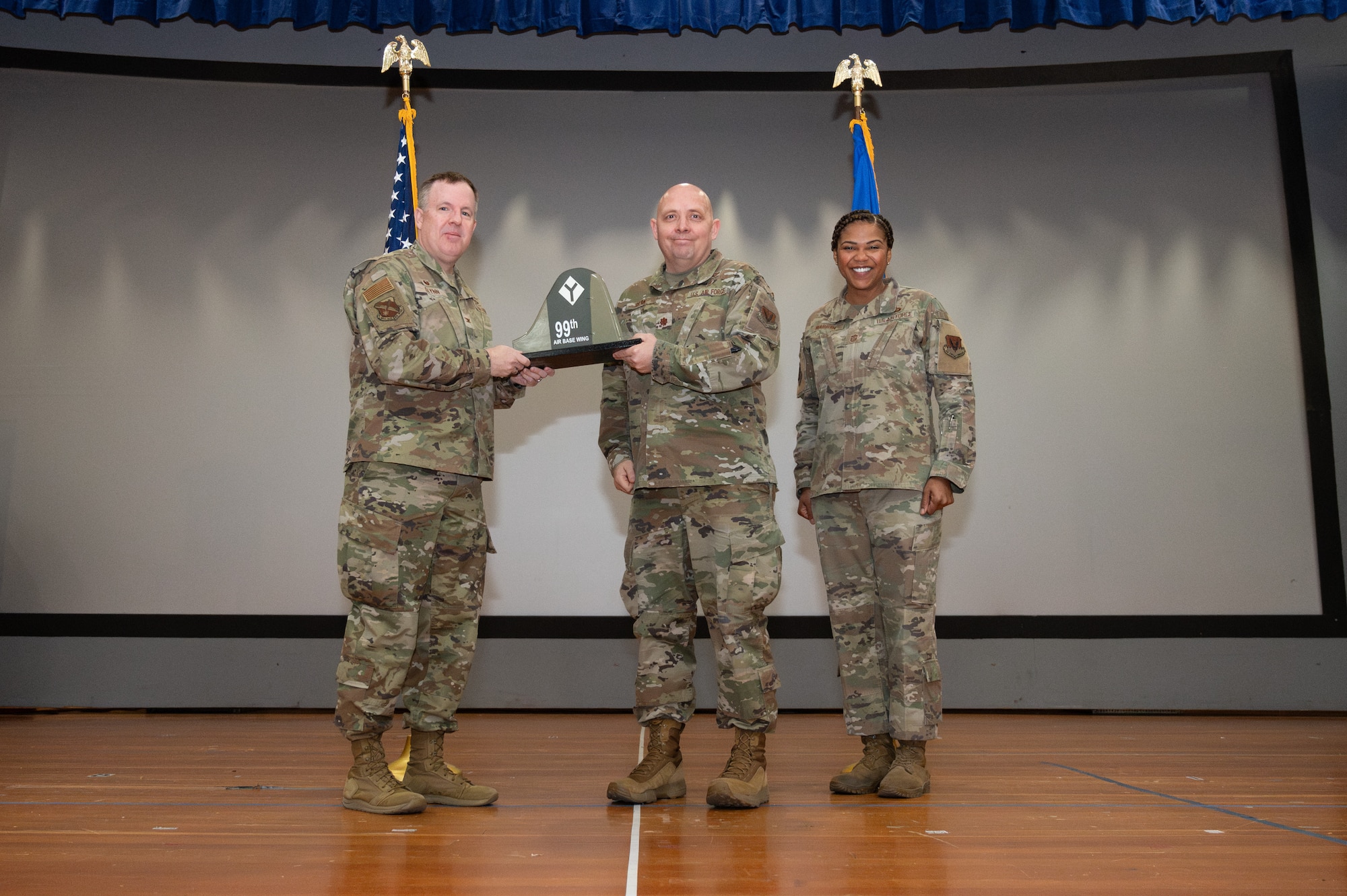 An Airman receives an award from U.S. Air Force Col. Jason Glynn.