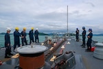 Sailors lower the anchor-and-chain aboard the Arleigh Burke-class guided-missile destroyer USS Michael Murphy (DDG 112).