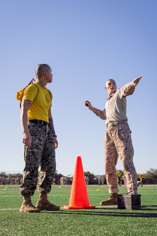 U.S. Marine Corps Sgt. Felipe Morales, a drill instructor with Echo Company, 2nd Recruit Training Battalion, instructs recruits during an introduction to a combat fitness training event at Marine Corps Recruit Depot San Diego, California, Nov. 13, 2024. The CFT is an annual fitness test that is required of all Marines to pass and maintain consisting of an 880-yard sprint, ammunition can lifts, and a maneuver under fire drill. (U.S. Marine Corps photo by Lance Cpl. Eric Valerio)