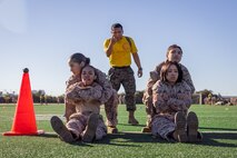 U.S. Marine Corps Sgt. Felipe Morales, a drill instructor with Echo Company, 2nd Recruit Training Battalion, instructs recruits during an introduction to a combat fitness training event at Marine Corps Recruit Depot San Diego, California, Nov. 13, 2024. The CFT is an annual fitness test that is required of all Marines to pass and maintain consisting of an 880-yard sprint, ammunition can lifts, and a maneuver under fire drill. (U.S. Marine Corps photo by Lance Cpl. Eric Valerio)