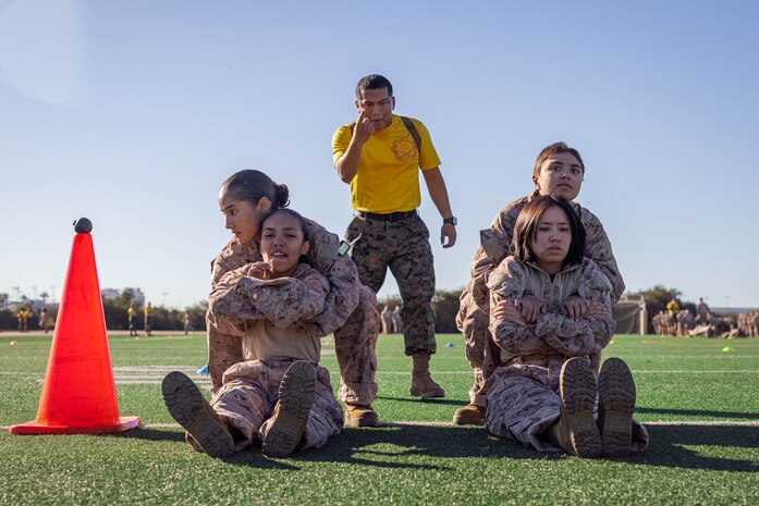 U.S. Marine Corps Sgt. Felipe Morales, a drill instructor with Echo Company, 2nd Recruit Training Battalion, instructs recruits during an introduction to a combat fitness training event at Marine Corps Recruit Depot San Diego, California, Nov. 13, 2024. The CFT is an annual fitness test that is required of all Marines to pass and maintain consisting of an 880-yard sprint, ammunition can lifts, and a maneuver under fire drill. (U.S. Marine Corps photo by Lance Cpl. Eric Valerio)
