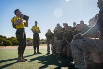 ​U.S. Marine Corps Sgt. Justin Vancil, a drill instructor with Echo Company, 2nd Recruit Training Battalion, demonstrates ammunition can lifts during an introduction to a combat fitness training event at Marine Corps Recruit Depot San Diego, California, Nov. 13, 2024. The CFT is an annual fitness test that is required of all Marines to pass and maintain consisting of an 880-yard sprint, ammunition can lifts, and a maneuver under fire drill. (U.S. Marine Corps photo by Lance Cpl. Eric Valerio)