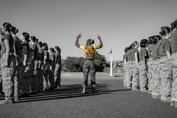 U.S. Marine Corps Sgt. Takiyah Wesley, a drill instructor with Echo Company, 2nd Recruit Training Battalion, instructs recruits during an introduction to a combat fitness training event at Marine Corps Recruit Depot San Diego, California, Nov. 13, 2024. The CFT is an annual fitness test that is required of all Marines to pass and maintain consisting of an 880-yard sprint, ammunition can lifts, and a maneuver under fire drill. (U.S. Marine Corps photo illustration by Lance Cpl. Eric Valerio)