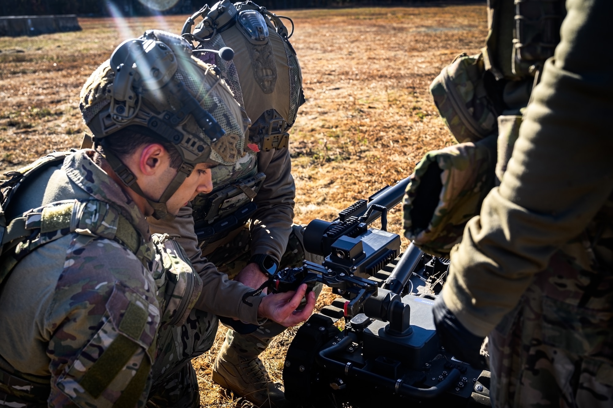 U.S. Air Force Senior Airman Nicholas Izzo, Senior Airman Carson Gregg and Staff Sgt. Justin Sommer, 87th Civil Engineer Squadron explosive ordnance disposal technicians, rig a man transportable robotics system at Joint Base McGuire-Dix-Lakehurst, N.J., Nov. 13, 2024. The 87th CES EOD unit underwent a four-day training involving three teams of three technicians who worked through 20 intricate scenarios as part of an annual training qualification. (U.S. Air Force photo by Senior Airman Matt Porter)