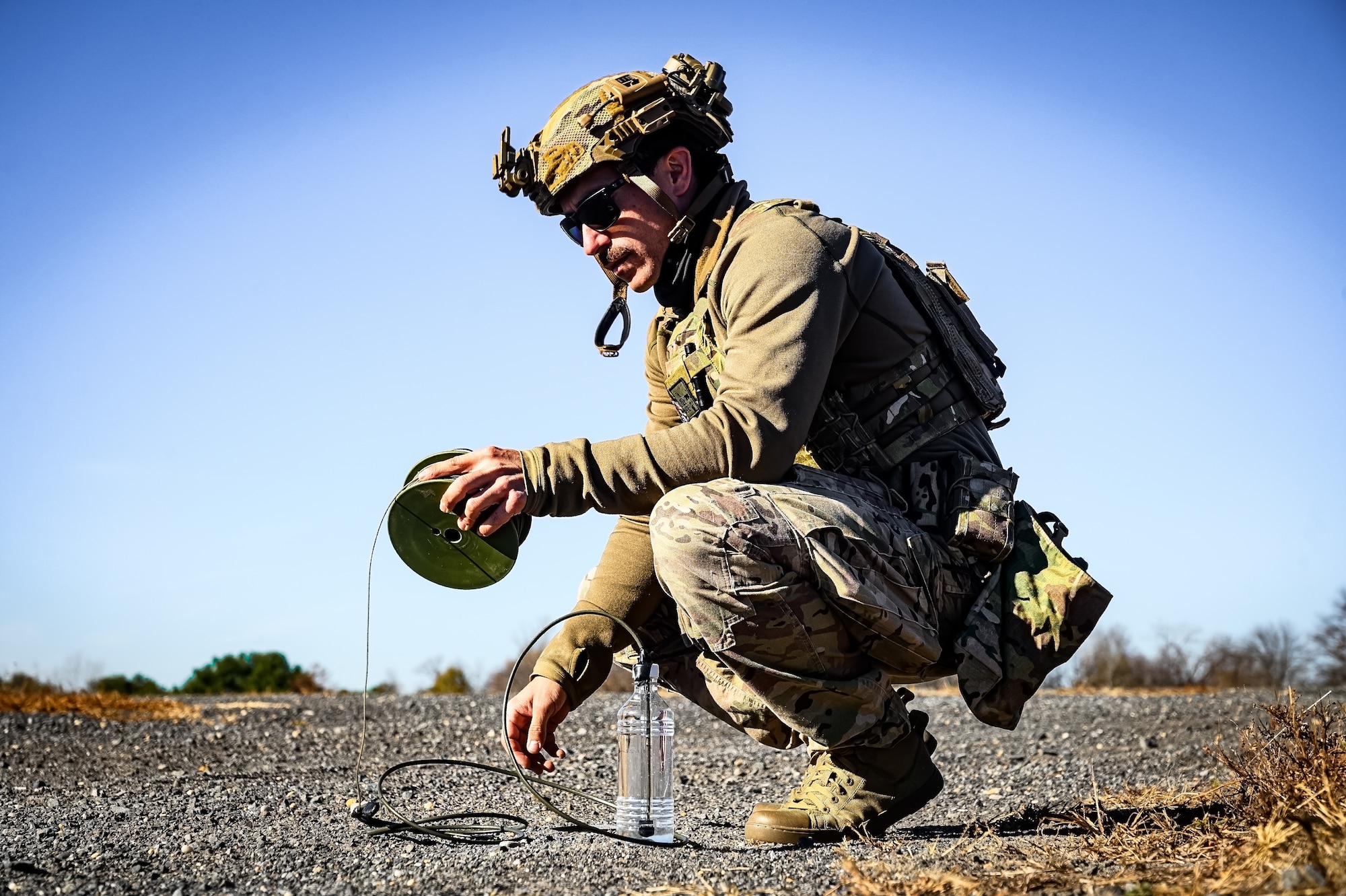 U.S. Air Force Staff Sgt. Justin Sommer, 87th Civil Engineer Squadron explosive ordnance disposal technician, surveys loose soil at Joint Base McGuire-Dix-Lakehurst, N.J., Nov. 13, 2024. The 87th CES EOD unit underwent a four-day training involving three teams of three technicians who worked through 20 intricate scenarios as part of an annual training qualification. (U.S. Air Force photo by Senior Airman Matt Porter)