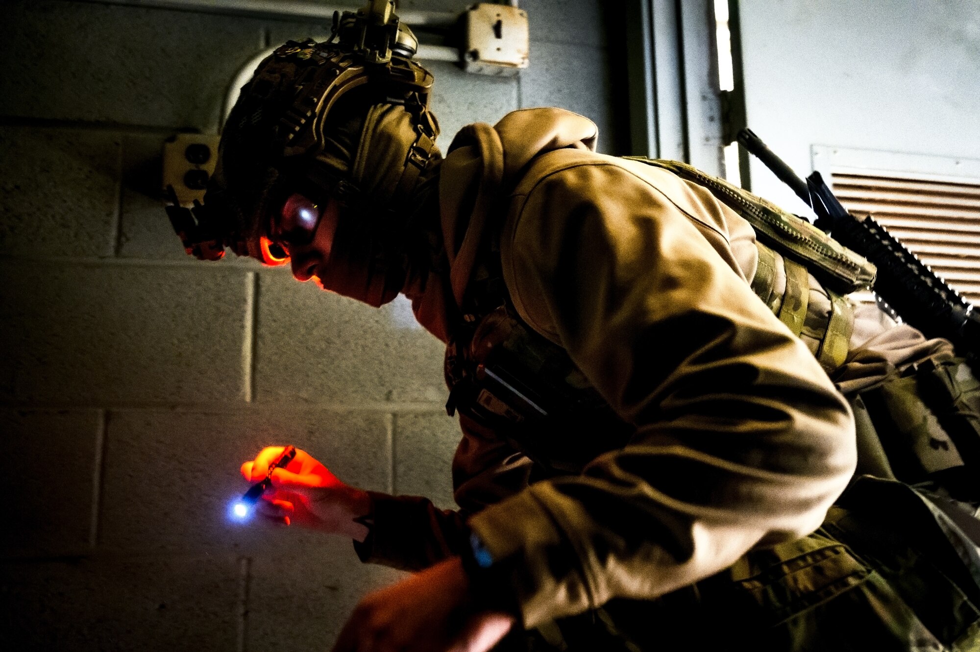 U.S. Air Force Senior Airman Carson Gregg, 87th Civil Engineer Squadron explosive ordnance disposal technician, surveys a room at Joint Base McGuire-Dix-Lakehurst, N.J., Nov. 15, 2024. The 87th CES EOD unit underwent a four-day training involving three teams of three technicians who worked through 20 intricate scenarios as part of an annual training qualification. (U.S. Air Force photo by Senior Airman Matt Porter)