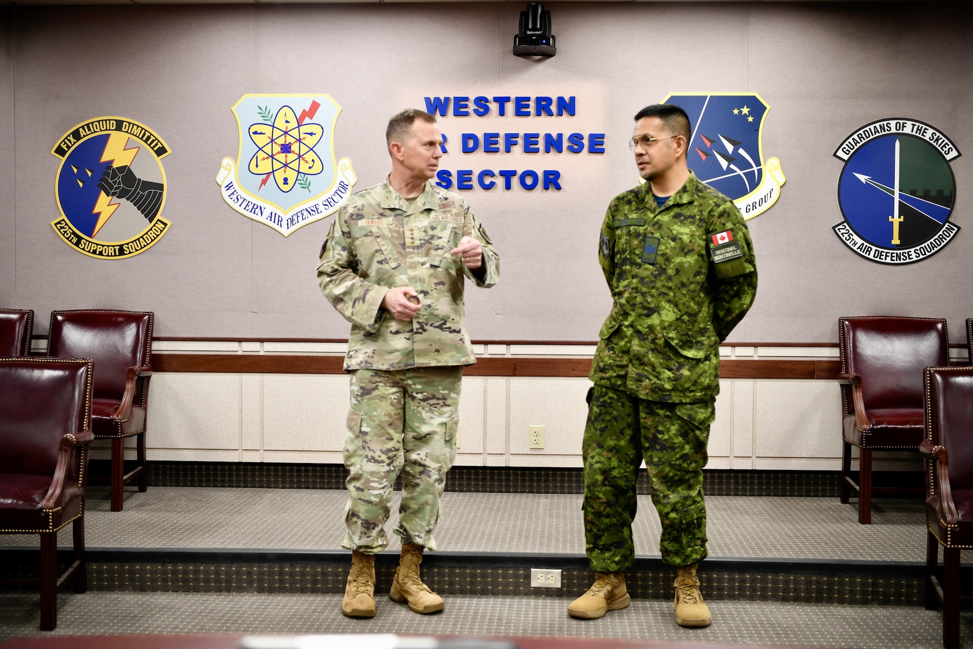 The NORAD commander shakes Royal Canadian Air Force Sgt. Anthony Lewis' hand