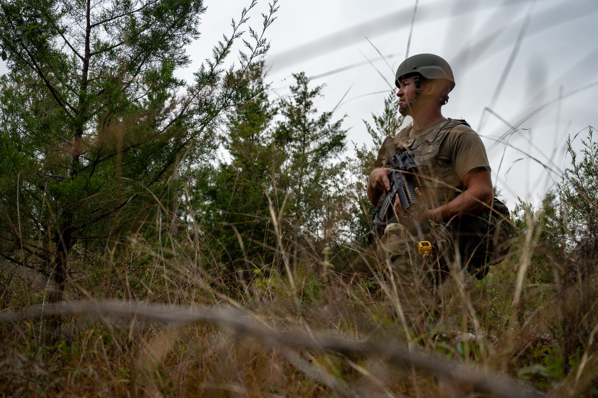 U.S. Airmen prepare to engage with simulated attacking forces during a bivouac exercise at Eglin Range, Eglin Air Force Base, Florida, Nov. 6, 2024. The bivouac exercise covered multiple disciplines needed to ensure Airmen are prepared for real-world scenarios such as land navigation, tactical combat casualty care and base defense. (U.S. Air Force photo by Senior Airman Hussein Enaya)