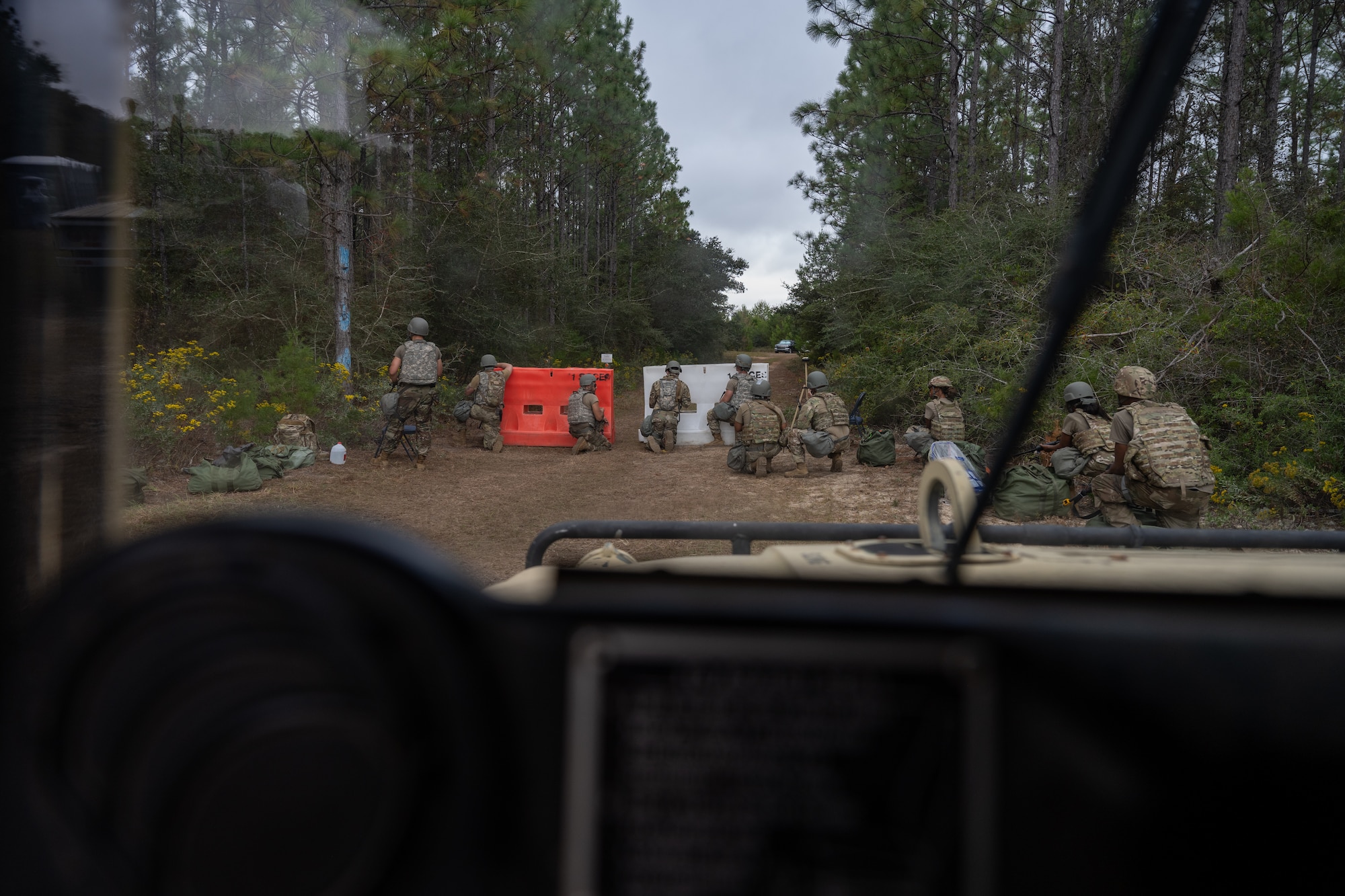 U.S. Airmen prepare to engage with simulated attacking forces during a bivouac exercise at Eglin Range, Eglin Air Force Base, Florida, Nov. 6, 2024. The bivouac exercise covered multiple disciplines needed to ensure Airmen are prepared for real-world scenarios such as land navigation, tactical combat casualty care and base defense. (U.S. Air Force photo by Senior Airman Hussein Enaya)