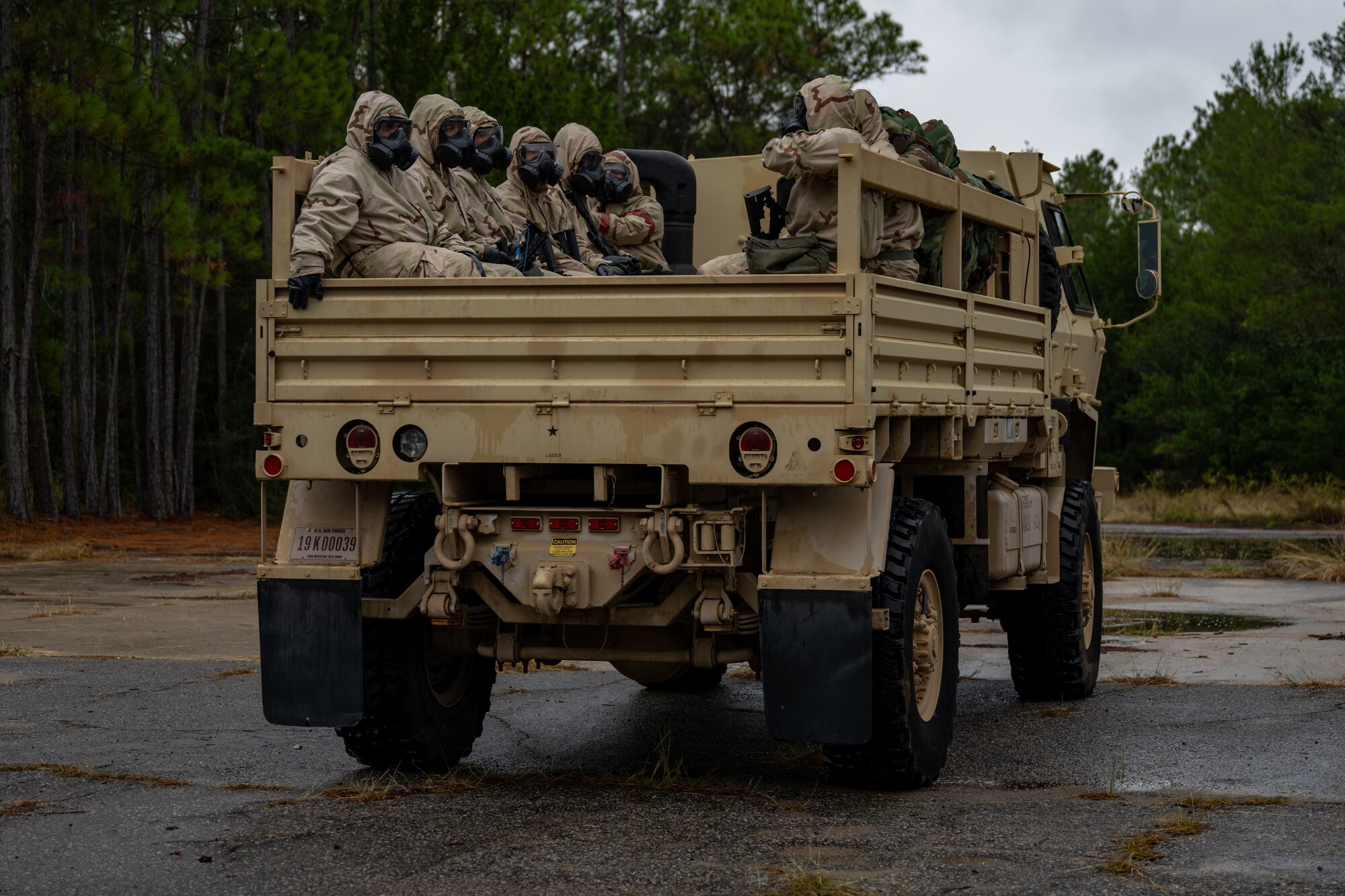 U.S. Airmen, assigned to Hurlburt Field, are transported to a gas chamber during a bivouac exercise at Eglin Range, Eglin Air Force Base, Florida, Nov. 6, 2024. The purpose of the gas chamber exercise is to enable Airmen to maintain familiarity with the proper use of their M50 protective mask, including how to efficiently and properly clear and seal their mask when entering the chamber. (U.S. Air Force photo by Senior Airman Hussein Enaya)