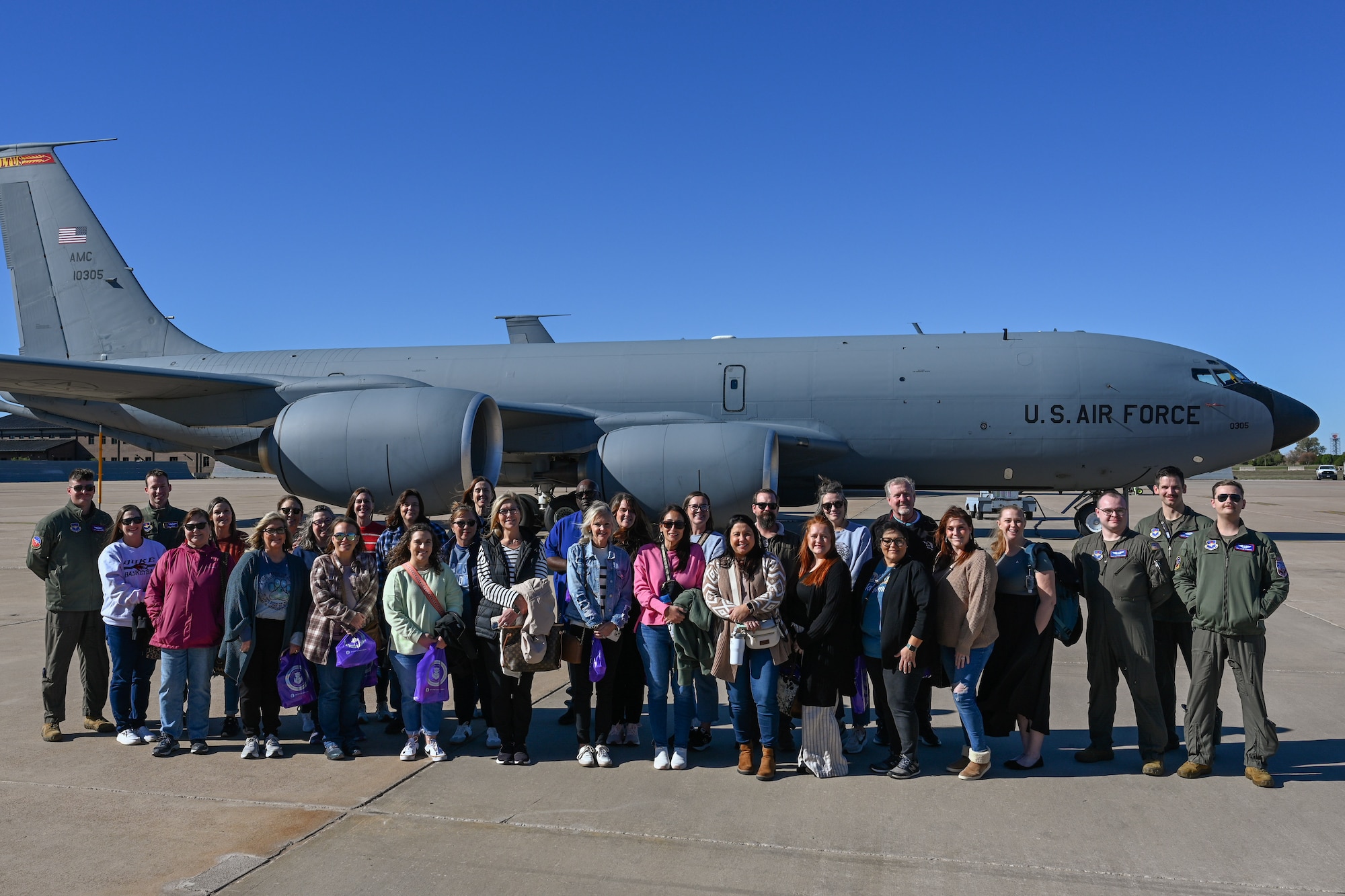 Teachers from Southwest Oklahoma and Airmen from the 97th Air Mobility Wing (AMW) pose for a photo in front of a KC-135 Stratotanker aircraft at Altus Air Force Base, Oklahoma, Nov. 21, 2024. The 97 AMW invited teachers from the local area to experience a military aircraft flight. (U.S. Air Force photo by Airman 1st Class Jonah Bliss)