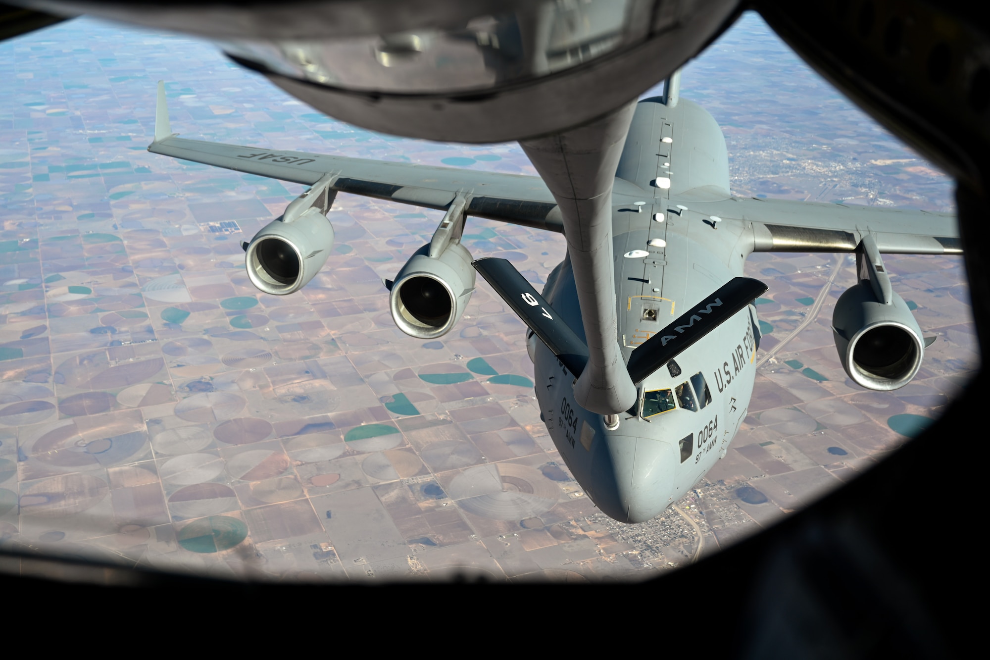 A C-17 Globemaster III aircraft assigned to Altus Air Force Base, Oklahoma, receives fuel from a KC-135 Stratotanker aircraft over the skies of Texas, Nov. 21, 2024. The C-17 is the Air Force's most versatile cargo aircraft. (U.S. Air Force photo by Airman 1st Class Jonah Bliss)
