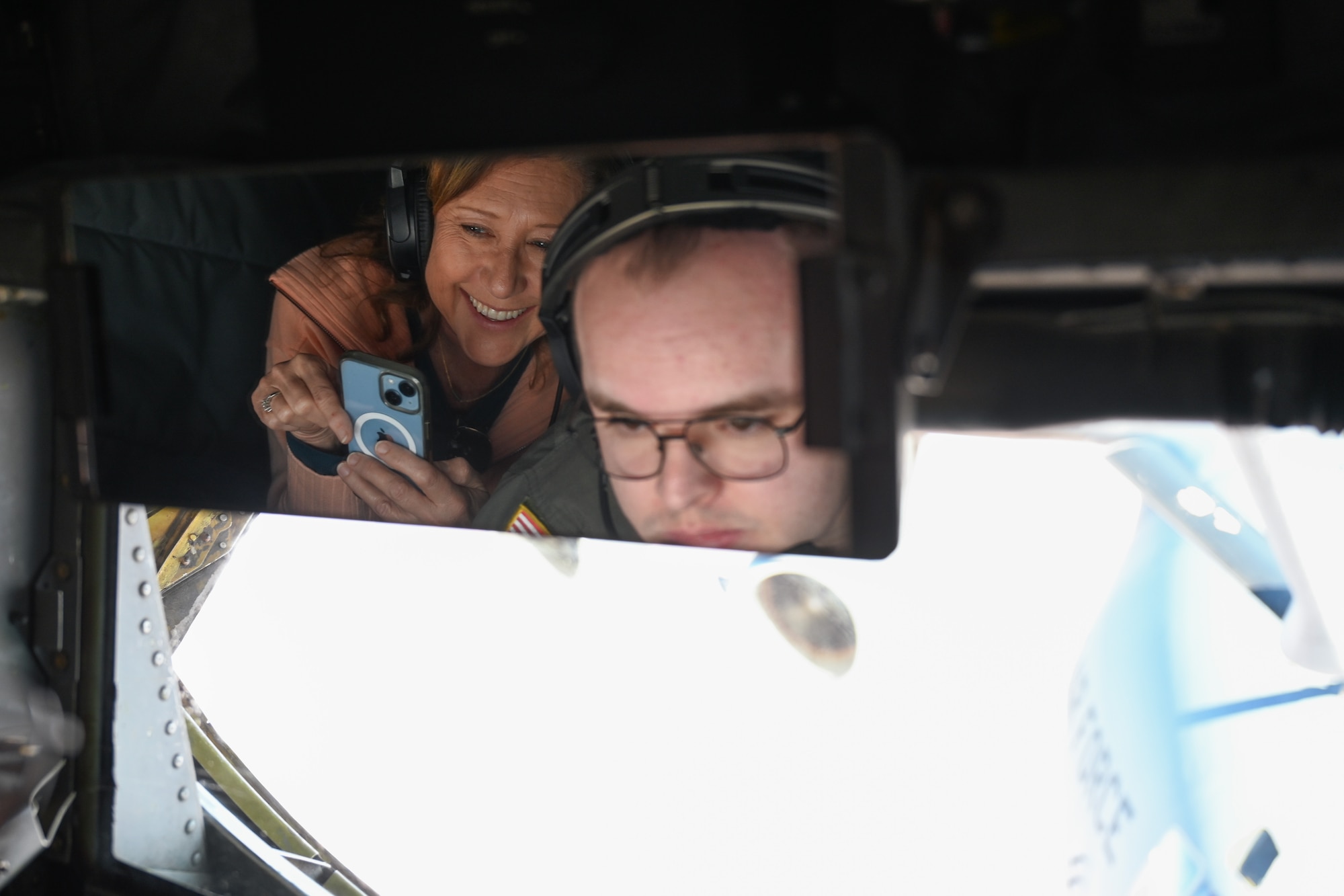 Wendy Howard, Frederick Public School science teacher, watches U.S. Air Force Staff Sgt. Matthew Baxter, 54th Air Refueling Squadron instructor boom operator, refuel a C-17 Globemaster III aircraft over the skies of Texas, Nov. 21, 2024. The 97th Air Mobility Wing invited teachers from the local area on a military flight for an opportunity to showcase the mission to educators who influence the next generation. (U.S. Air Force photo by Airman 1st Class Jonah Bliss)