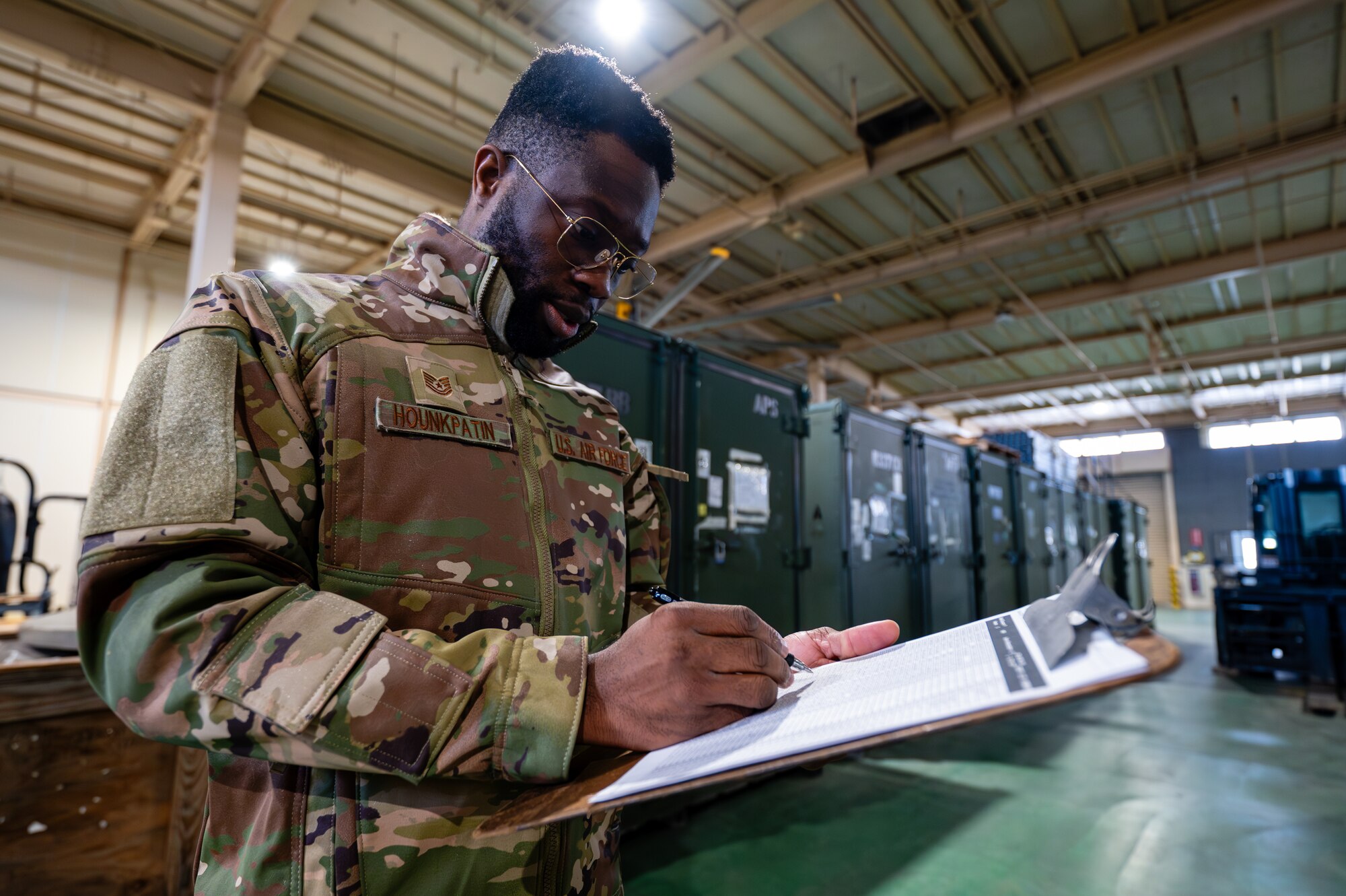 U.S. Air Force Tech. Sgt. Semevo Hounkpatin, 374th Logistics Readiness Squadron inventory and inspection section chief, conducts an inventory of aircraft maintenance items for Operation Christmas Drop 2024 at Yokota Air Base, Japan.