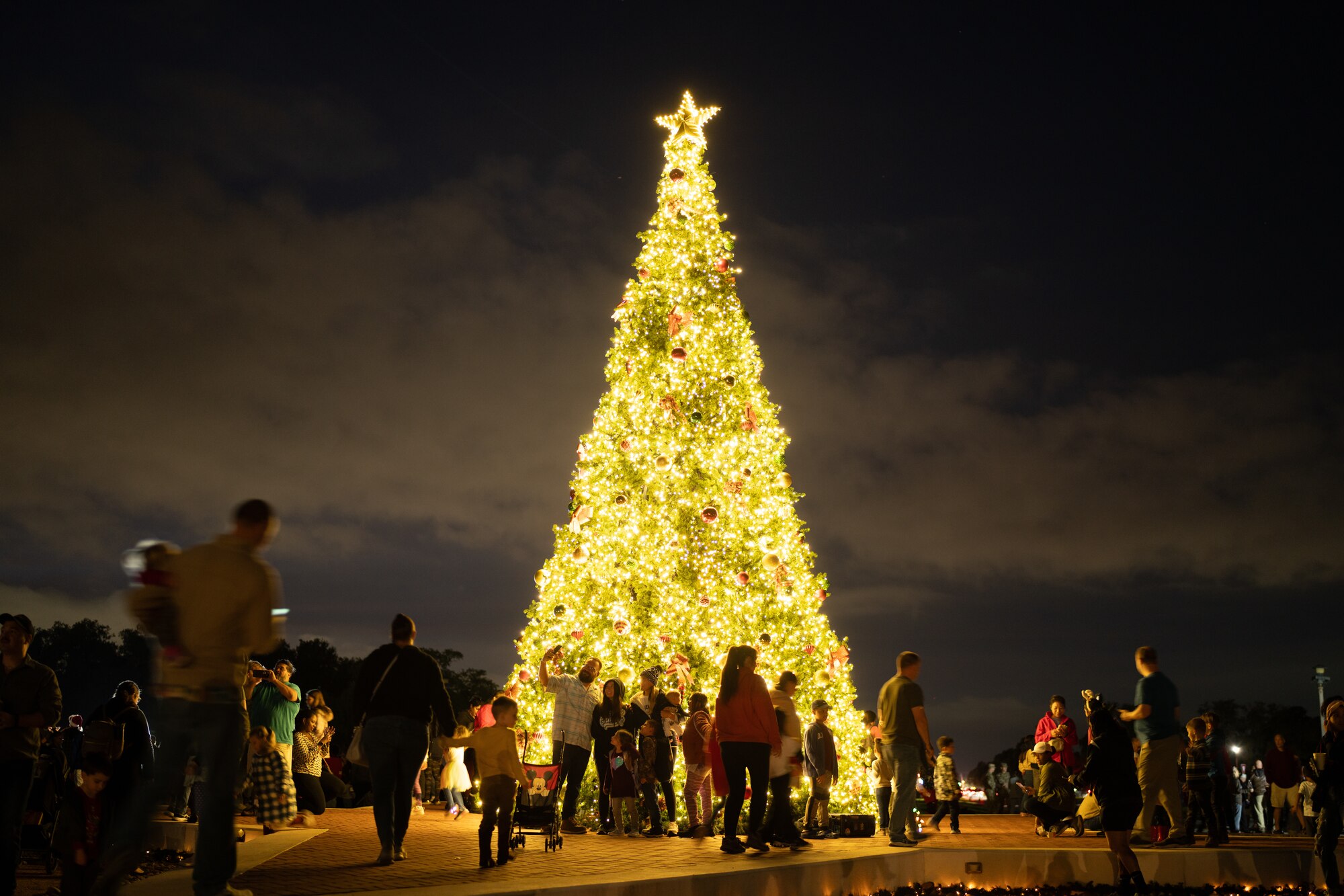 Families mix and mingle around the holiday tree, Nov. 30, 2023 Joint Base San Antonio-Randolph, Texas.
