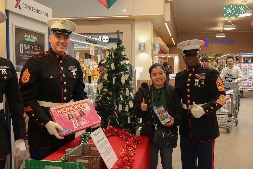 From right, U.S. Marine Corps Sgt. Maj. Ismael Bamba, Command Senior Enlisted Leader of U.S. Marine Corps Forces Korea, and Staff Sgt. Jonathan Hemme, a career planner with MARFORK, poses for a photo alongside a civilian during the Gifts for Hope toy drive at U.S. Army Garrison Humphreys, South Korea, Nov. 29, 2024. Gifts for Hope is an annual two-day toy drive that MARFORK hosts in partnership with the Seoul Children’s Welfare Committee during the holidays to collect and donate gifts to orphans in South Korea.