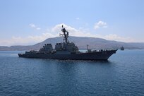 The guided-missile destroyer USS Bulkeley (DDG 84) sails in Chania harbor to the guided-missile destroyer USS Arleigh Burke (DDG 51) to assume a nested mooring configuration, Aug. 22, 2024