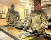 New York Army National Guard Staff Sgts. Joshua Diamond and Yorby Fernandez-Tejada with the 1501st Quartermaster Company (Field Feeding), 369th Sustainment Brigade, prepare eggs during the 42nd Infantry Division’s command post exercise at Fort Indiantown Gap, Pa., Nov. 24, 2024. This was the 1501st FFC’s first official large-scale support mission. (U.S. Army National Guard photo by 2nd Lt. Rivkah Weissberger)