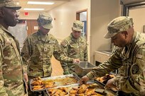 New York Army National Guard Sgt. 1st Class Desmond Hall, a platoon sergeant with the 1501st Quartermaster Company (Field Feeding), 369th Sustainment Brigade, demonstrates food preparation to his Soldiers during the 42nd Infantry Division’s command post exercise at Fort Indiantown Gap, Pa., Nov. 24, 2024. This was the 1501st FFC’s first official large-scale support mission. (U.S. Army National Guard photo by 2nd Lt. Rivkah Weissberger)