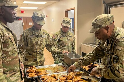 New York Army National Guard Sgt. 1st Class Desmond Hall, a platoon sergeant with the 1501st Quartermaster Company (Field Feeding), 369th Sustainment Brigade, demonstrates food preparation to his Soldiers during the 42nd Infantry Division’s command post exercise at Fort Indiantown Gap, Pa., Nov. 24, 2024. This was the 1501st FFC’s first official large-scale support mission. (U.S. Army National Guard photo by 2nd Lt. Rivkah Weissberger)
