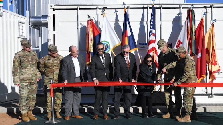 The Hon. Rachel Jacobson, assistant secretary of the Army, Installations, Energy and Environment, and Maj. Gen. David Doyle, commanding general, 4th Infantry Division and Fort Carson, cut the ceremonial ribbon celebrating a new energy-efficient, large flow battery system pilot program Nov. 20, 2024, on Fort Carson. The ceremony marks construction completion of a customer-sited, large redox flow battery which has been dubbed “GridStar Flow” by its Lockheed Martin designers. The ribbon-cutting included Patrick Appleman, center right, director of the U.S. Army Installation Management Command-Readiness; 4th Infantry Division and Fort Carson Command Sgt. Maj. Alex Kupratty, far right; Fort Carson Garrison Commander Col. Erik Oksenvaag, second from left; Garrison Command Sgt. Maj. Jason Mortensen, left; Dr. Andrew Nelson, middle left, director, Construction Engineering Research Laboratory, U.S. Army Engineer Research and Development Center, U.S. Army Corps of Engineers; and Steven Botwinik, vice president, Advanced Program Execution and Transition, Lockheed Martin Missiles and Fire Control.