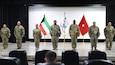 Soldiers from the 606th Quartermaster Detachment stand on stage after receiving a plaque, an award, and a right shoulder sleeve insignia during the unit’s end of tour ceremony in the U.S. Central Command area of responsibility, Oct. 13, 2024.