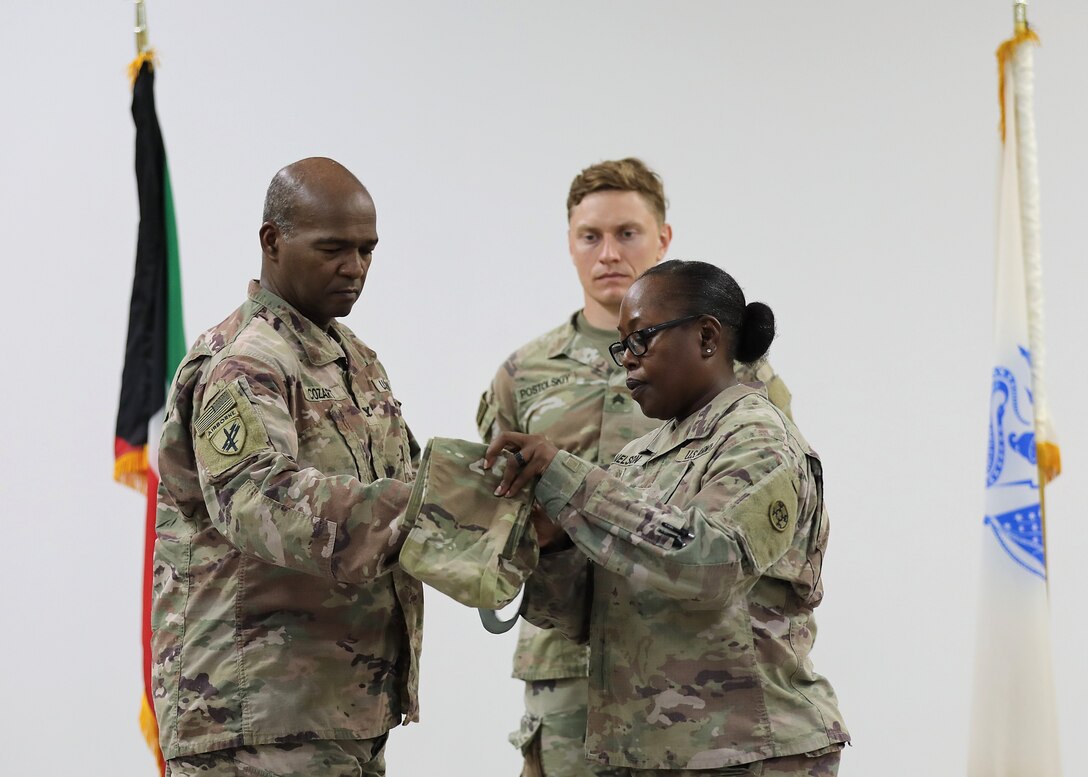 Leaders case their unit guidon on stage.