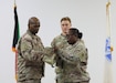 Col. James A. Cozart, director, 398th Finance Management Support Center and Command Sgt. Maj. LaWanda T. Nelson, senior enlisted advisor, case the guidon during an end of tour casing ceremony in the U.S. Central Command area of responsibility, Oct. 12, 2024.