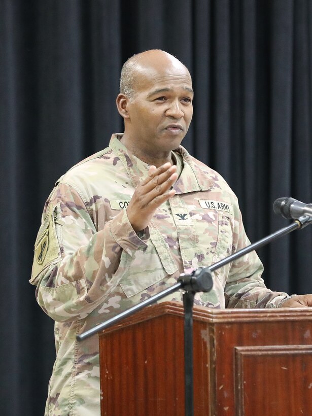 Leader speaks to audience during a ceremony.