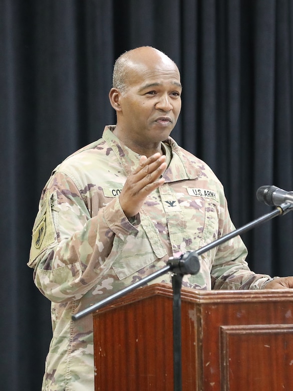 Leader speaks to audience during a ceremony.