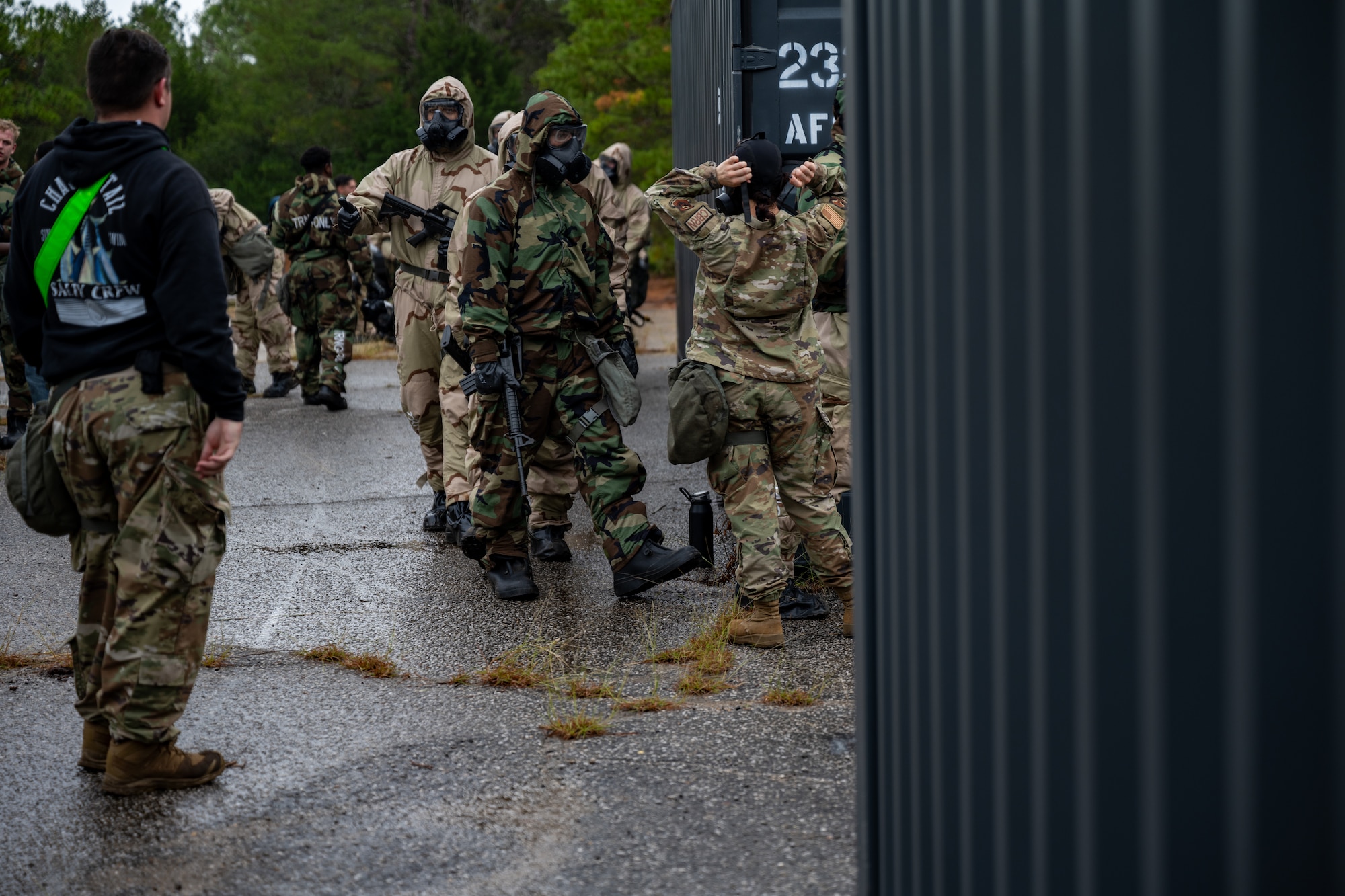 U.S. Airmen, assigned to Hurlburt Field, prepare to enter a gas chamber at Eglin Range during a bivouac exercise at Eglin Air Force Base, Florida, Nov. 6, 2024. The purpose of the gas chamber exercise is to enable Airmen to maintain familiarity with the proper use of their M50 protective mask, including how to efficiently and properly clear and seal their mask when entering the chamber. (U.S. Air Force photo by Senior Airman Hussein Enaya)