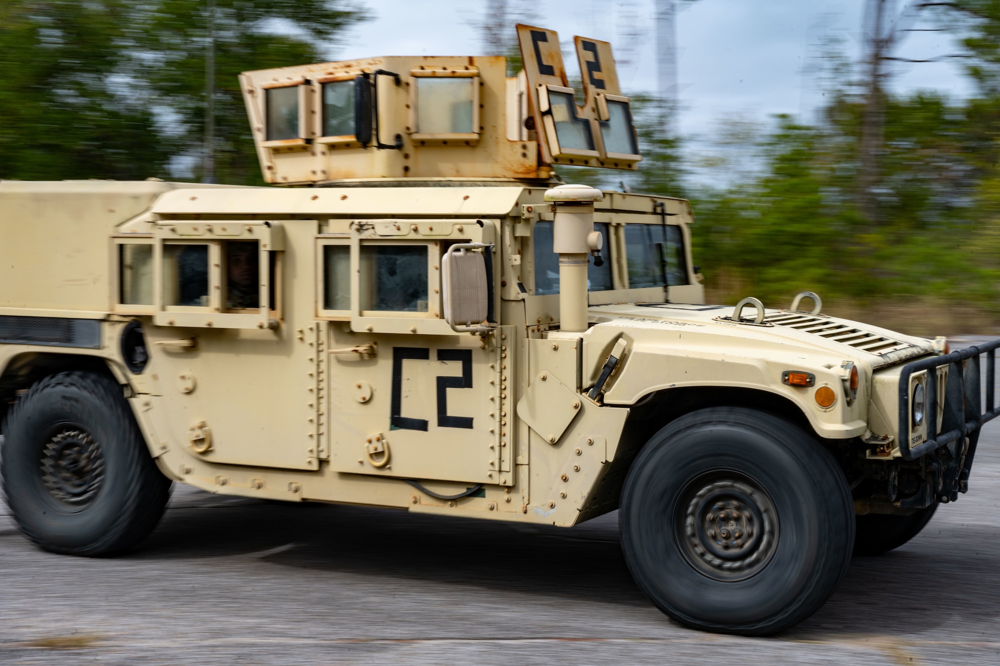 A U.S. Airman, assigned to the 1st Special Operations Mission Support Group, drives a Humvee during a bivouac exercise on Eglin Range, Eglin Air Force Base, Florida, Nov. 3, 2024. The exercise simulated bare-base construction in contested territory, training Airmen in multiple skills such as operational security and the ability to survive and operate in a hostile environment ensuring readiness anytime, anywhere. (U.S. Air Force photo by Senior Airman Hussein Enaya)