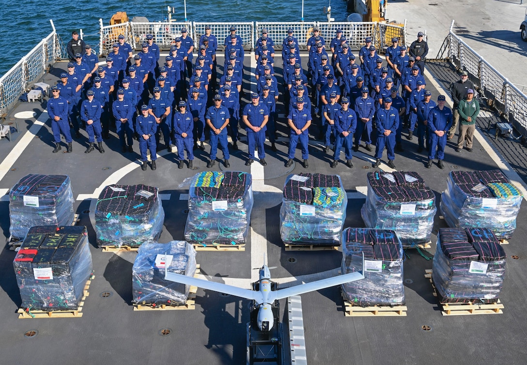 The crew of Coast Guard Cutter Hamilton pose with more than 16,100 pounds of cocaine worth an assessed street value of approximately $182.8 million in Port Everglades, Florida, Dec. 2, 2024. Hamilton's crew worked alongside an embarked Coast Guard Helicopter Interdiction Tactical Squadron aircrew, interagency, and international partners to interdict illicit narcotics in the international waters of the Eastern Pacific Ocean. (U.S. Coast Guard photo by Petty Officer 3rd Class Eric Rodriguez)