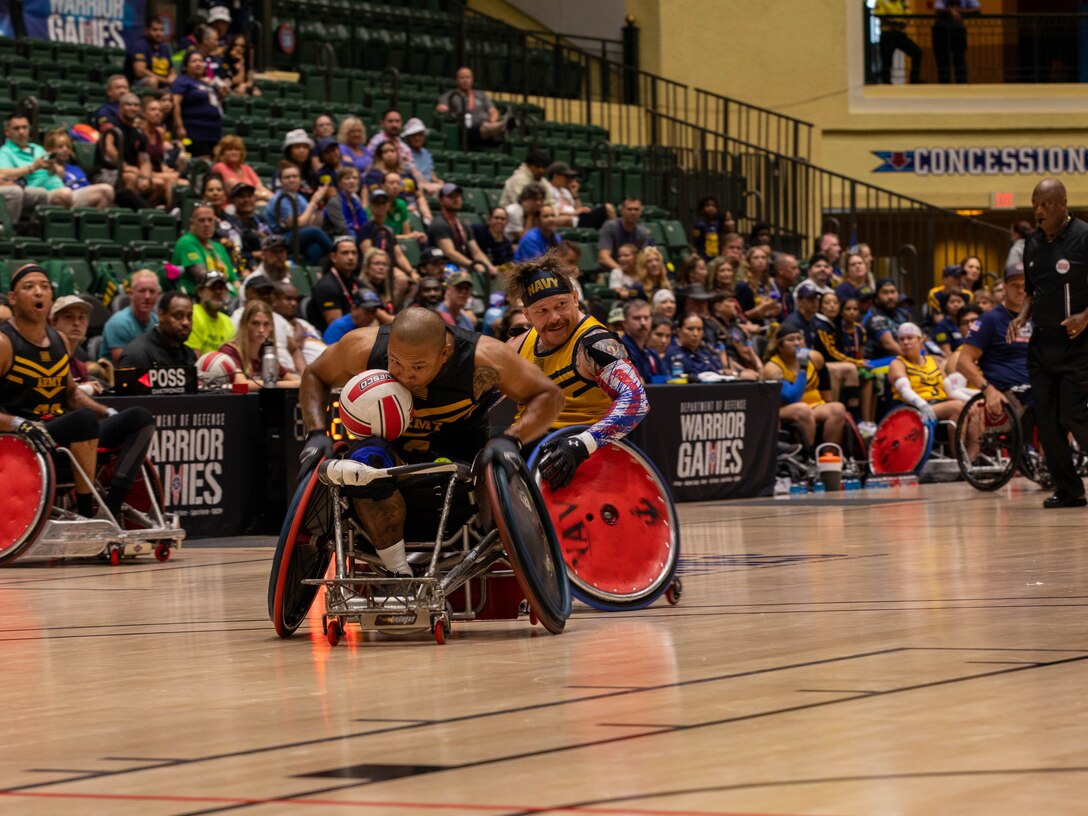 U.S. Army Veteran Staff Sgt Gene Calantoc steals the ball in wheelchair rugby at the 2024 DOD Warrior Games