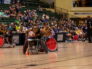 U.S. Army Veteran Staff Sgt Gene Calantoc steals the ball in wheelchair rugby at the 2024 DOD Warrior Games