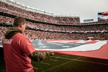 A U.S. Airman holds the American Flag during the National Anthem before the San Francisco 49ers Salute to Service game vs. the Seattle Seahawks at Levi’s Stadium Santa Clara, California. Nov. 17, 2024. U.S. service members participated in the Salute to Service game to help honor the nation's service members, veterans and their families. (U.S. Marine Corps photo by Cpl. Sarah M. Grawcock)