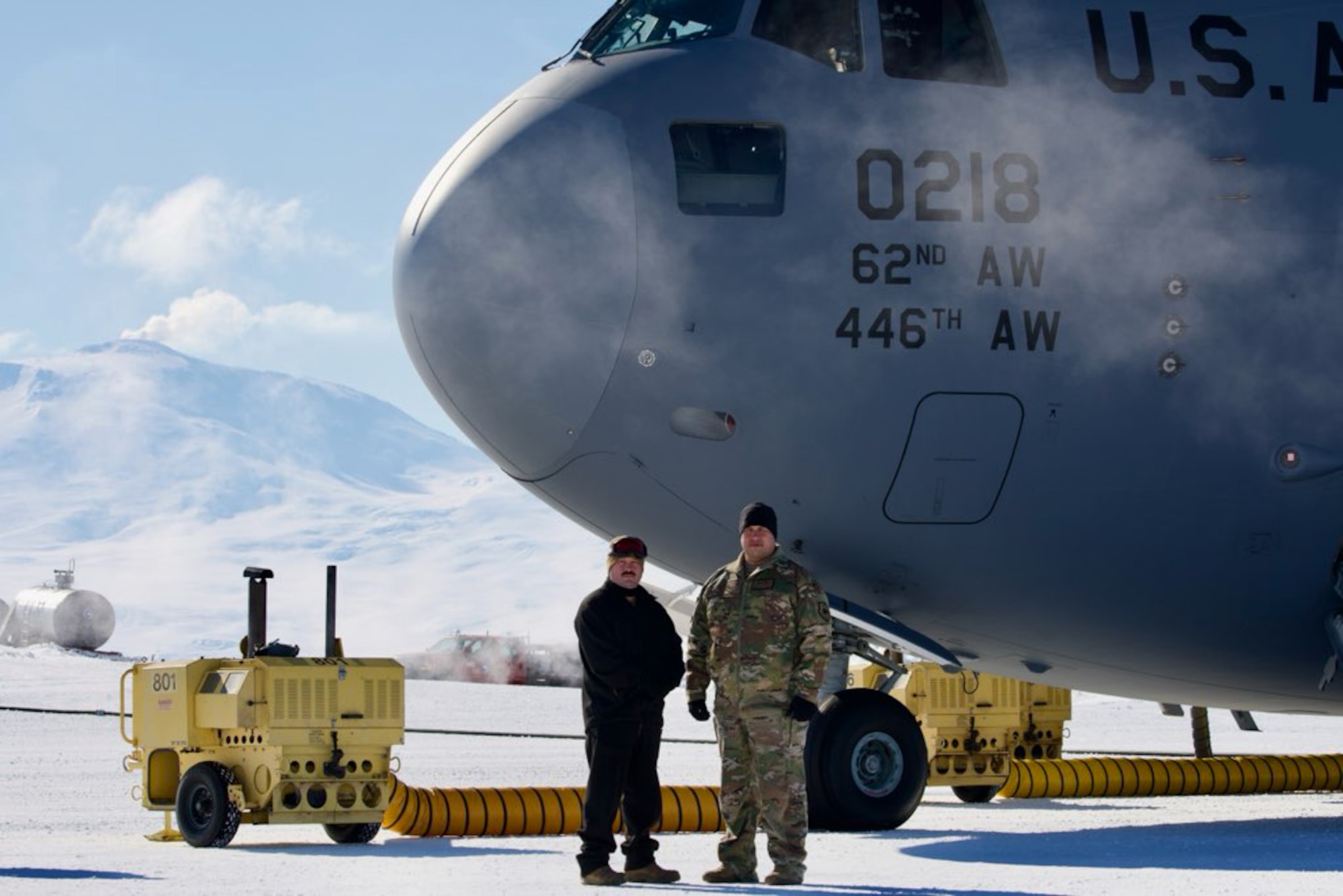 Chief Master Sgt. James Bolling, 446th Airlift Wing command chief, and Col. Joseph Vanoni, 446th AW commander, stand by a C-17 Globemaster III in Antarctica as part of a visit to Operation Deep Freeze on Nov. 13, 2024