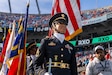 U.S. Army Sgt. 1st Class Katrina Smith-Gravesande prepares to lead the color guard during a National Football League (NFL) Salute to Service game in Charlotte, NC, Nov. 24, 2024. The joint-service Honor Guard included members of all military branches, representing United States service-members who have or currently serve our nation. (U.S. Army Reserve photo by Sgt. Cameron Hershberger)