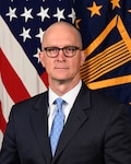 Mr. Matthew Giles Deputy Director poses for his official portrait.