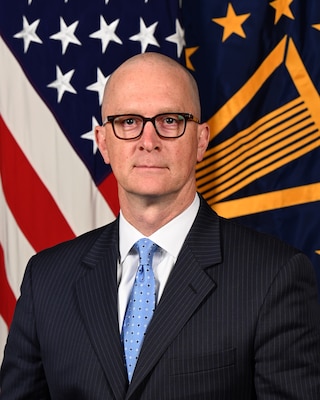 Mr. Matthew Giles Deputy Director poses for his official portrait.
